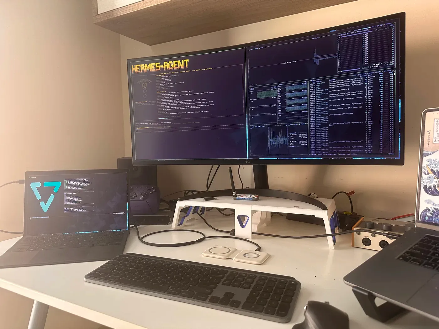 The rig: the Z13 on the left, and everything it's running on the monitor — Hermes Agent on one half, btop on the other